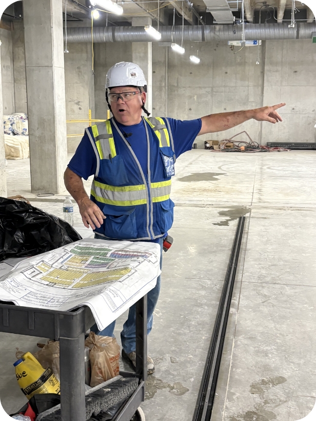 Installer on job site reviewing plans